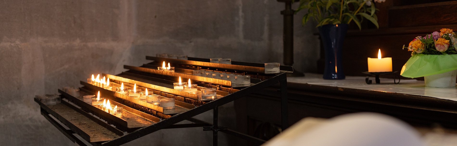 votive altar in church with emtpy guestbook